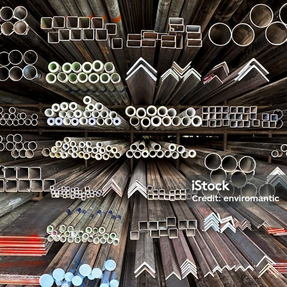 Various angle iron profiles and steel rods kept in storage shelves in a steel shop.